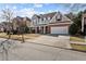 Two-story house with brick and siding, featuring a large front porch and attached garage at 1481 Wild Rye Ln, Grayson, GA 30017