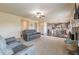 Open living room features plush seating and views into the kitchen and dining area at 171 Osier Dr, Mcdonough, GA 30252
