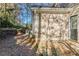 Backyard patio with HVAC unit, retaining wall, and wooded area at 2755 Sherlock Dr, Decatur, GA 30034