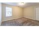 Bright bedroom with neutral walls, plush carpet, and a single window at 2755 Sherlock Dr, Decatur, GA 30034