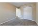 Empty bedroom with double closet doors and neutral-toned walls at 2755 Sherlock Dr, Decatur, GA 30034