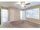 Spacious bedroom with plush carpeting, ceiling fan, and multiple windows at 2755 Sherlock Dr, Decatur, GA 30034