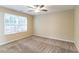 Empty bedroom with beige walls, large window, and plush carpeting at 2755 Sherlock Dr, Decatur, GA 30034