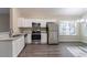 Bright and airy kitchen featuring white cabinetry, stainless steel appliances, and granite countertops at 2755 Sherlock Dr, Decatur, GA 30034
