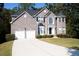 Traditional two-story brick home with a two-car garage and landscaped front yard at 3688 Eagles Beek Cir, Lithonia, GA 30038