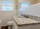Updated bathroom with granite vanity and white tile at 2126 River Rd, Ellenwood, GA 30294