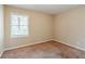 Well-lit bedroom with neutral walls and carpet at 2126 River Rd, Ellenwood, GA 30294