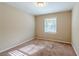Bright bedroom featuring neutral walls and carpet at 2126 River Rd, Ellenwood, GA 30294