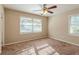 Bedroom with ceiling fan and neutral decor at 2126 River Rd, Ellenwood, GA 30294