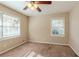 Bright bedroom with ceiling fan and large window at 2126 River Rd, Ellenwood, GA 30294