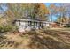 Ranch house with mature trees and a grassy yard at 2126 River Rd, Ellenwood, GA 30294