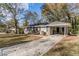 Front view of a ranch house with a carport and landscaping at 2126 River Rd, Ellenwood, GA 30294