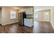 Eat-in kitchen with white cabinets and stainless steel fridge at 2126 River Rd, Ellenwood, GA 30294