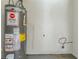 Small laundry room with Rheem water heater at 2126 River Rd, Ellenwood, GA 30294