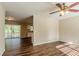 Living room with hardwood floors, leading to kitchen and patio at 2126 River Rd, Ellenwood, GA 30294