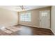 Living room with hardwood floors, ceiling fan and door at 2126 River Rd, Ellenwood, GA 30294