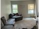 Living room with gray couches, carpeted flooring, and wall decor at 2090 Oak Park Ln, Decatur, GA 30032