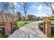 Brick driveway with open gates leading to a large home at 710 Cox Rd, Roswell, GA 30075