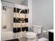 Clean bathroom with black and white shower curtain and a tub at 1142 Preserve Park Dr, Loganville, GA 30052