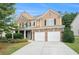 Brick two-story house with a large driveway and landscaping at 1142 Preserve Park Dr, Loganville, GA 30052