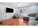Spacious living room with hardwood floors and a 3D accent wall at 1142 Preserve Park Dr, Loganville, GA 30052