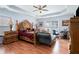 Large main bedroom with wood floors and ornate bed at 1142 Preserve Park Dr, Loganville, GA 30052