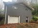 Detached gray brick garage with a white overhead door at 2277 Maxwell Sw Dr, Atlanta, GA 30311