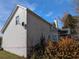 Side view of a white two-story house with a satellite dish at 405 Baneberry Bnd, Peachtree City, GA 30269