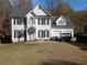Two-story house with white siding, black shutters, and a pink door at 405 Baneberry Bnd, Peachtree City, GA 30269