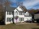 Two-story house with white siding, black shutters, and a pink door at 405 Baneberry Bnd, Peachtree City, GA 30269