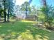 Large backyard with grassy area and wooded privacy at 5940 Old Bill Cook Rd, Atlanta, GA 30349