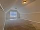 Bright bonus room with two windows, wall paneling, and carpet at 5940 Old Bill Cook Rd, Atlanta, GA 30349