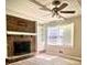 Living room with brick fireplace and ceiling fan at 5940 Old Bill Cook Rd, Atlanta, GA 30349