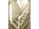 Elegant staircase with carpeted steps and white railing at 5940 Old Bill Cook Rd, Atlanta, GA 30349
