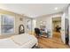 Bedroom with a bed, desk, wood floors, and open doorway at 41 Plantation Ne Dr # A, Atlanta, GA 30324