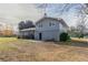 Exterior view of a two-story home with gray siding and a grassy backyard at 1151 Martin Rd, Stone Mountain, GA 30088