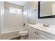 Clean bathroom with white tile, a bathtub, vanity, and toilet at 1151 Martin Rd, Stone Mountain, GA 30088