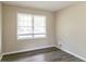 Empty bedroom with wood-look flooring, a large window, and neutral-colored walls at 1151 Martin Rd, Stone Mountain, GA 30088