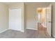 Bedroom with double closet doors, carpeting, and a view down the hallway at 1151 Martin Rd, Stone Mountain, GA 30088