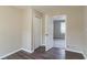 Bedroom with wood-look flooring, neutral paint, a closet, and a doorway leading to another room at 1151 Martin Rd, Stone Mountain, GA 30088