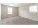 Spacious, empty bedroom with neutral-colored walls and carpeting at 1151 Martin Rd, Stone Mountain, GA 30088