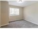 Empty bedroom with neutral walls, carpeting, and a large window at 1151 Martin Rd, Stone Mountain, GA 30088
