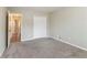 Empty bedroom with gray carpet, white closet, and open door to hallway at 1151 Martin Rd, Stone Mountain, GA 30088