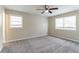 Spacious bedroom with carpeting, ceiling fan, and ample natural light at 1151 Martin Rd, Stone Mountain, GA 30088