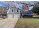 Charming two-story home with gray brick and siding, a red door, and a two-car garage at 1151 Martin Rd, Stone Mountain, GA 30088