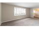 Bright living room with a large window, neutral paint, and gray carpeting at 1151 Martin Rd, Stone Mountain, GA 30088