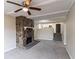 Living room with a stone fireplace, carpeted flooring, and a view towards the kitchen at 1151 Martin Rd, Stone Mountain, GA 30088