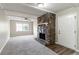 Living room featuring a stone fireplace, carpeted floors, and a ceiling fan at 1151 Martin Rd, Stone Mountain, GA 30088