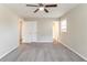Main bedroom with ceiling fan, carpeted floors, and access to a bathroom at 1151 Martin Rd, Stone Mountain, GA 30088