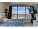 Bedroom featuring a comfortable bed, large windows providing scenic city views, and a wall-mounted TV at 3338 Ne Peachtree Ne Rd # 1102, Atlanta, GA 30326